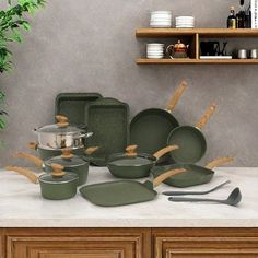 green pots and pans are sitting on the counter