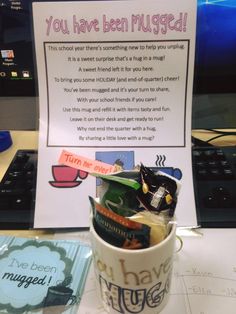 a coffee cup filled with random items next to a sign that says you have been mugged