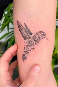 a small hummingbird tattoo on the right thigh