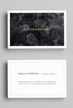 two business cards with black and white swirls