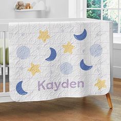 a baby crib with a personalized blanket on it