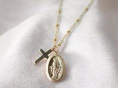 ∙ ∙ O V A L ∙ M A R Y ∙ C R O S S ∙ N E C K L A C E ∙ ∙ Made with the following: 14K Gold Filled Virgin Mary Pendant 21mm x 12mm 14K Gold Filled Cross Pendant 16mm x 10mm 14K Gold Filled Findings  14K Gold Filled Lobster Claw 14K Gold Filled Chain This listing is for one necklace.  ∙ ∙ H O W ∙ T O ∙ O R D E R ∙ ∙ Please select the chain and length from the drop-down menu. Please select if you would like a 2-inch extender chain from the drop-down menu. The 2-inch extender gives you the flexibilit Jewelry Layering Necklace, Cross Necklace Gold, Virgin Mary Pendant, Jewelry Layering, Mary Necklace, Figaro Necklace, Fairy Jewelry, Necklace For Her, Gold Cross Necklace