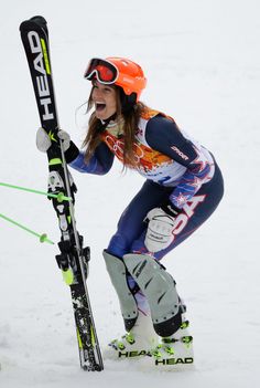 a woman on skis in the snow with her mouth open