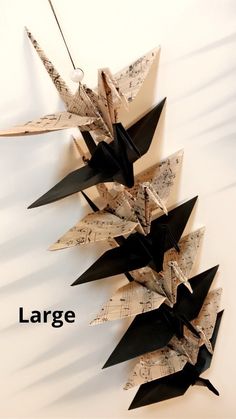 an origami bird made out of sheet music notes with the words large below it