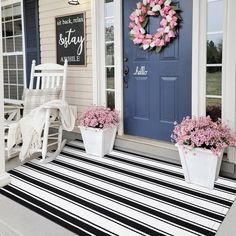 the front porch is decorated with pink flowers