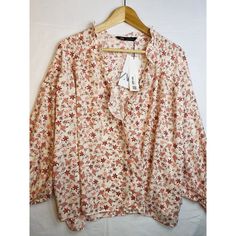 This Zara Blouse Is A Perfect Addition To Any Wardrobe. With A Beautiful Floral Pattern And Cute Ruffle Cuffs, It Is Sure To Catch The Eye. The Top Is Brand New With Tags And Comes In A Size X-Large. It Is A Relax-Wide Fit And Has A Floral Peach And Red Design That Will Match With A Variety Of Outfits. New Zara Paisley * Protection Of Old-Growth Forest* Reducton Of Water And Energy* Reduction Of Emissionscondition : New With Tag * Size : Xl * Pit To Pit : 58 Inches - Laying Flat * Pit To Cuff: 1 Feminine Zara Blouse For Fall, Chic Zara Blouse With Floral Print, Zara Printed Blouse For Fall, Zara Printed Blouse For Day Out, Zara V-neck Printed Blouse, Zara Feminine Floral Print Tops, Feminine Zara Tops With Floral Print, Zara Printed V-neck Blouse, Zara Floral Print Blouse For Brunch