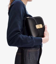 A.P.C. Women's bag. - Trapezoidal shape. - Flap closure with clasp. - Cowhide suede lining under flap. - Goldtone "A.P.C. rue Madame Paris" logo embossed on front. - Adjustable shoulder strap. - One large compartment and two additional ones. - Cotton blend lining. - Goldtone hardware. - May be carried on shoulder or across chest. Modern Evening Saddle Bag With Turn-lock Closure, Luxury Evening Saddle Bag With Turn-lock Closure, Luxury Saddle Bag With Turn-lock Closure For Evening, Modern Saddle Bag With Magnetic Closure For Evening, Chic Business Saddle Bag With Palladium Hardware, Timeless Rectangular Saddle Bag For Evening, Chic Business Saddle Bag With Turn-lock Closure, Formal Rectangular Saddle Bag With Turn-lock Closure, Chic Evening Saddle Bag With Palladium Hardware