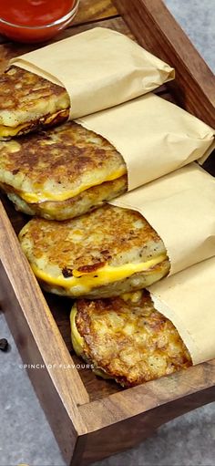 some pancakes are sitting in a wooden tray