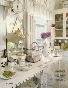 a white table topped with lots of dishes and cups