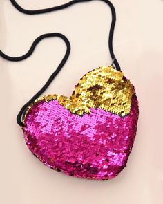 Carrying your belongings doesn't have to be boring, it can actually be magical. This open hear bag is great to take a few things on the go. 7'' W x 6'' H20'' shoulder strap lengthZip closureSpot clean Sparkle Purse, Hot Pink And Gold, Pretty Purses, Heart Purse, Sequin Mask, Rainbow Leggings, Sequin Purse, Sequin Leggings, Girls Heart