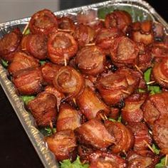 there are many sausages in the tin foil on the table, ready to be eaten