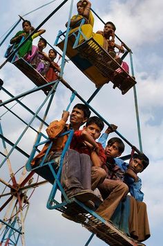 several people are riding on a ferris wheel