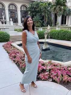 a woman standing in front of a fountain