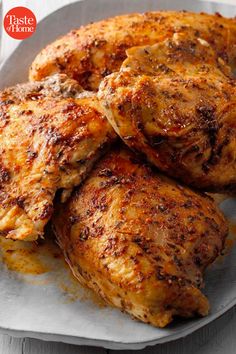 three pieces of chicken sitting on top of a white plate