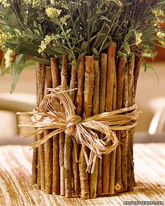 a bunch of sticks wrapped in twine and tied with a bow are sitting on a table