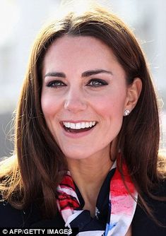 a smiling woman wearing a red, white and blue scarf