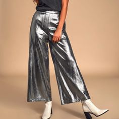 -Silver Metallic Wide Leg Cropped Pant -High Waisted -95% Polyester/5% Spandex -Brand New Never Worn! Silver Shiny Disco Bottoms, Shiny Silver Disco Bottoms, Disco Silver Shiny Bottoms, Glamorous Party Bottoms With Sheen, Glamorous Sheen Bottoms For Party, Metallic Shiny Bottoms For Party Season, Metallic Sheen Pants For Party, Party Pants In Metallic Color With Sheen, Metallic Party Pants With Sheen