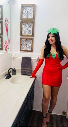 a woman in a red dress is standing in the bathroom