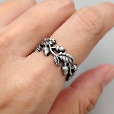 Embrace the timeless beauty of nature with our Oak Leaf and Acorn Ring. Handcrafted with sterling silver and designed in an oxidized style, these rings capture the essence of the wild forest and the bounty of nature. Each ring features intricate oak leaves and acorns, symbolizing strength, growth, and prosperity. Its open-style ring elegantly showcases the delicate details of the oak leaves and acorns. Celebrate your love with the beauty of the natural world with our open-style Oak Leaf and Acor Oak Leaf Ring, Acorn Ring, Oak Leaves And Acorns, Acorn Decorations, Nature Inspired Wedding, Fairytale Fashion, Wild Forest, Book Jewelry, Oak Leaves