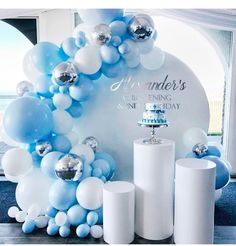 balloons and candles are on display in front of a backdrop