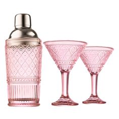 three pink glass goblets and a cocktail shaker on a white background with clippings