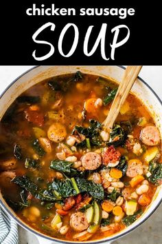 chicken sausage soup in a pot with spinach and carrots