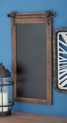 a blue wall with a mirror, lantern and candle on the shelf next to it