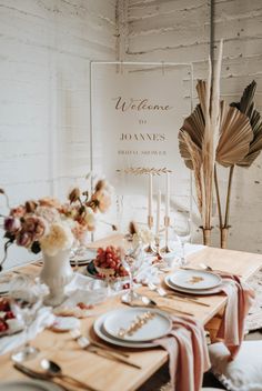 a dining table set with plates and place settings