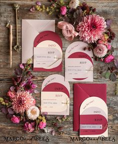 the wedding stationery is laid out with flowers