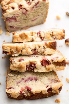 slices of strawberry bread stacked on top of each other with crumbled toppings