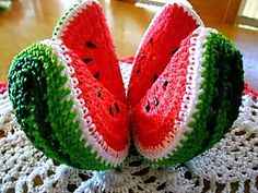 two pieces of watermelon sitting on top of a doily