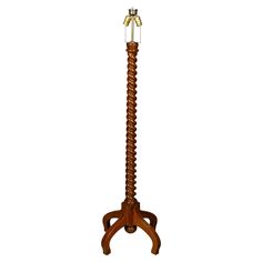 a tall wooden stand with a light on it's top and two legs in the middle