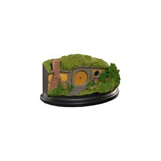 a miniature hobbot with trees and grass on it