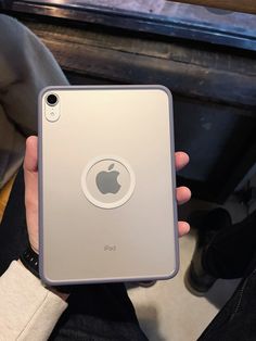 a person holding an ipad in their hand with the back cover removed from its case