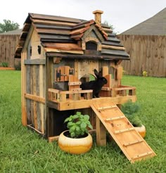 a small wooden house made out of pallets and wood planks in the grass