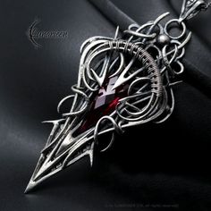 XANEHRTIAL  - Exclusive, gothic-style necklace. Fully handmade work (wire wrapping technique with oxidizing and polished silver). Main base gem: Red Quartz 16.2Ct (3,3g). Material: silver (Sterling Silver, Fine Silver / 925, 999). We use only high-quality silver.  Our silver does not contain harmful nickel. Chain length: 42 cm + 7 cm + 7 cm (Figaro) with handmade decorative clasp, adjustable. Pendant: length 7,5 cm, width 3,5 cm. Necklace weight: approx 20g. Color: Silver, Red. * * * * * * * * * Gothic Wire Wrapped Pendant Jewelry, Gothic Silver Wire Wrapped Jewelry, Gothic Sterling Silver Wire Wrapped Jewelry, Gothic Silver Wire Wrapped Necklace, Gothic Sterling Silver Necklace With Soldered Details, Special Gift For Girlfriend, Wire Wrapping Techniques, Red Quartz, Gothic Necklace