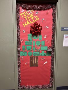 a door decorated to look like a christmas tree with presents on it and the words tech the hall's