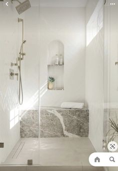 a bathroom with a walk in shower next to a sink