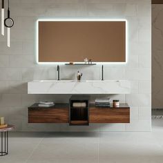 a modern bathroom with two sinks and a large mirror over it's countertop