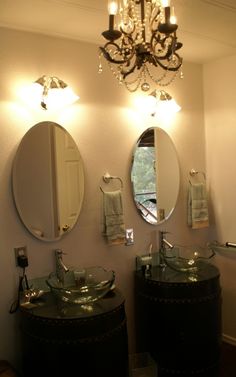 a bathroom with two sinks and a chandelier