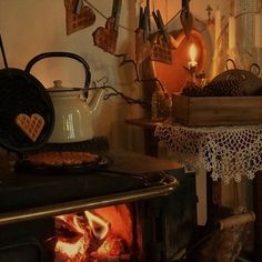 a stove top oven sitting inside of a kitchen next to a table with utensils on it