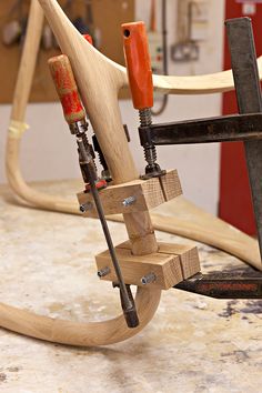 a close up of a wooden object on a table with woodworking tools in it