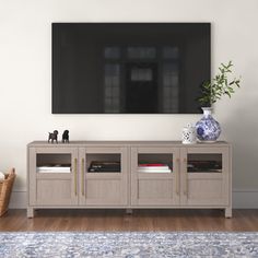 an entertainment center with a large flat screen tv mounted on the wall