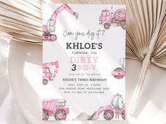 a pink tractor birthday party card on a table