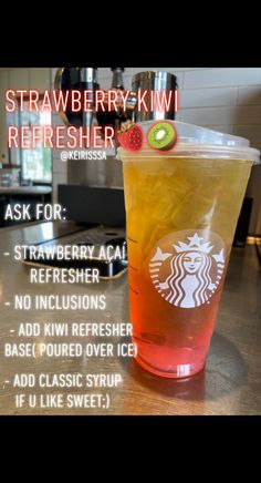 a drink in a plastic cup with strawberries on top and the words, strawberry - kiwi refresher