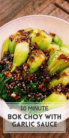 a white plate topped with cucumber and sesame seeds on top of a wooden table