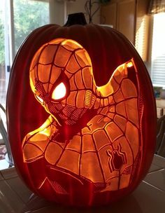 a spiderman pumpkin carved into the shape of a face