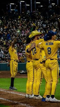 a group of baseball players standing on top of a field