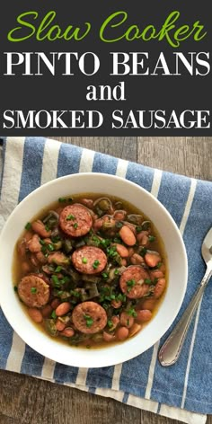 a white bowl filled with sausage and beans on top of a blue striped napkin next to a spoon