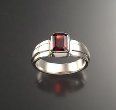 7x9mm natural Garnet is bezel-set with wide tapered band and raised center. These are beautifully cut, clean RED stones. I can set them in sizes 5 through 13. Specify size at check-out. Modern Ruby Ring With Bezel Setting For Anniversary, Formal Emerald Cut Ruby Ring With Bezel Setting, Formal Emerald-cut Ruby Ring With Bezel Setting, Modern Ruby Ring With Bezel Setting For Formal Occasions, Formal Rings With Bezel Setting And Rectangular Stone, Modern Rings With Rectangular Stone And Bezel Setting, Formal Jewelry With Bezel Setting And Wide Band, Formal Wide Band Jewelry With Bezel Setting, Birthstone Ring Mothers